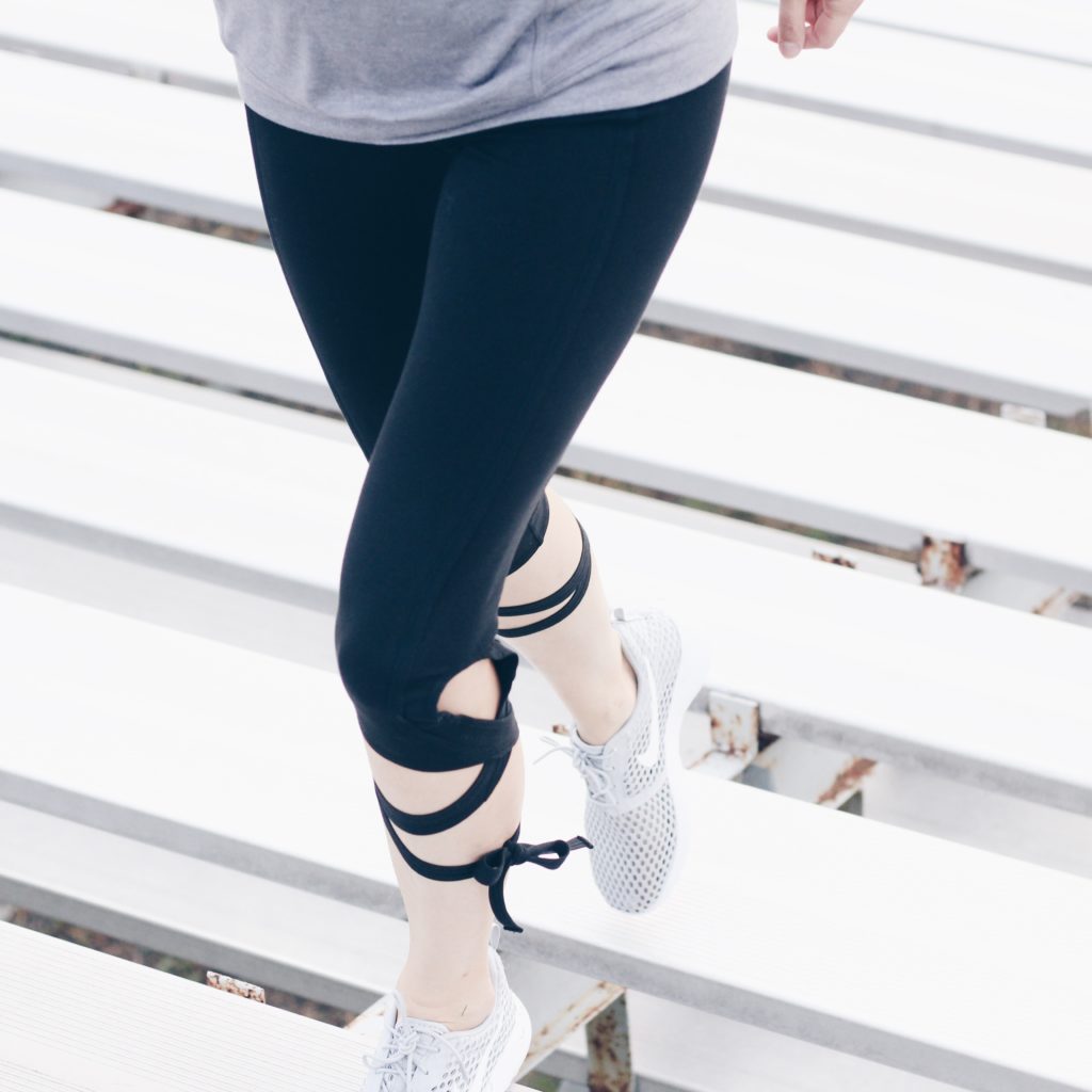 free people lace up leggings and sleeveless hoodie workout outfit gray nike sneakers