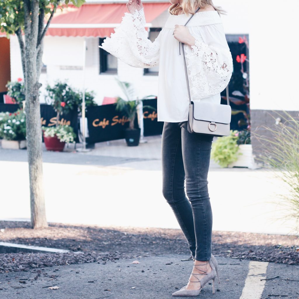 white bell sleeve top with gray jeans and lace up pumps