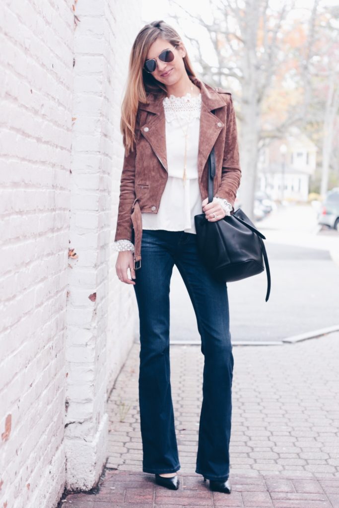 fall outfit idea: brown suede moto jacket with flare denim and bucket bag