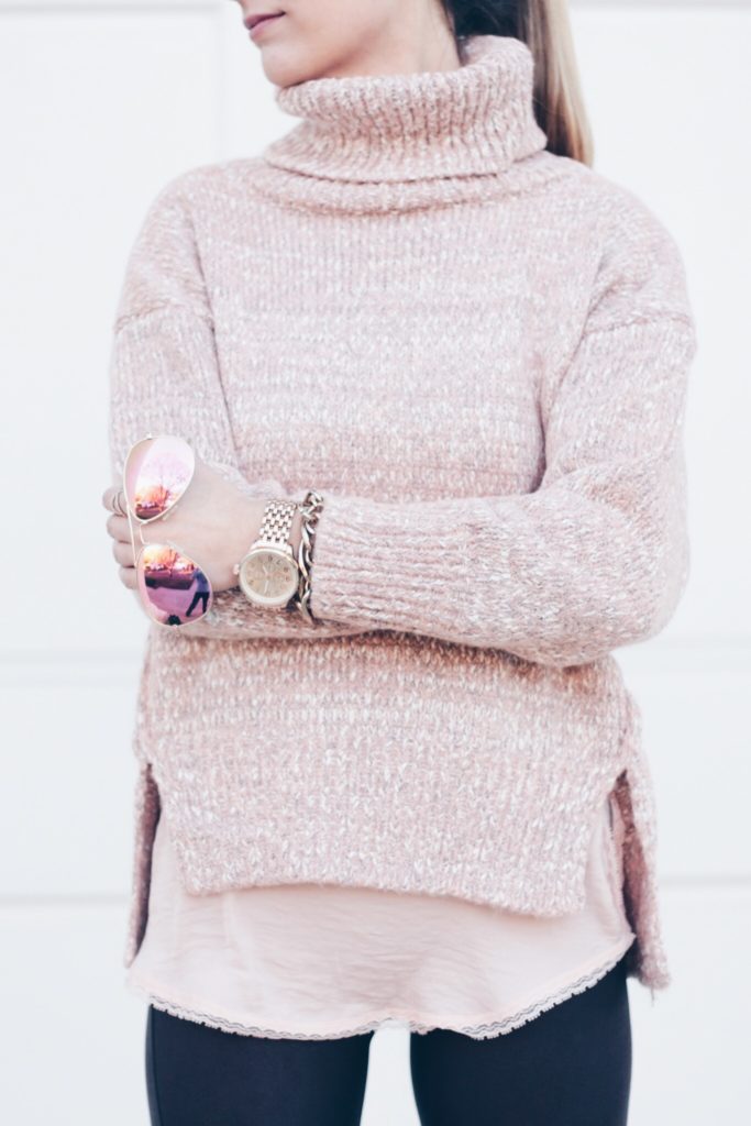 cozy pink turtleneck sweater over pink lace cami