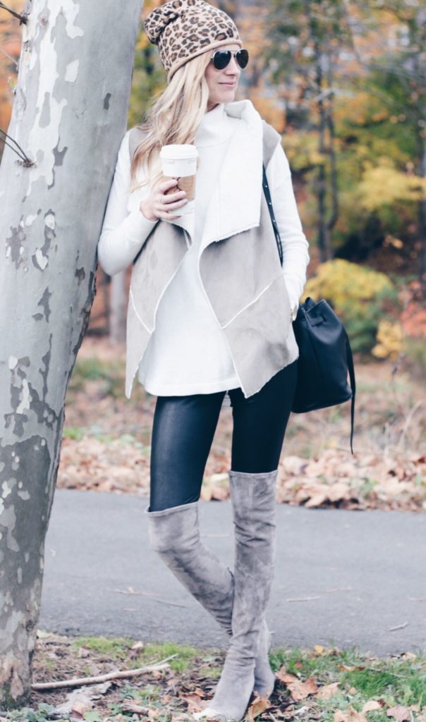 fall outfit: shearling vest with leather leggings and suede over the knee boots and leopard beanie
