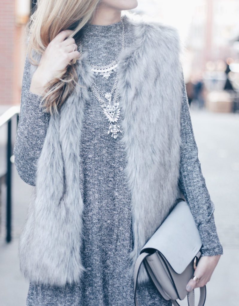 gray fur vest and silver bib necklace