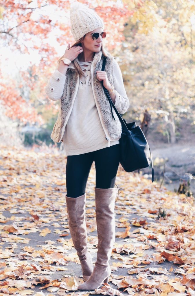Connecticut life and style blogger, Pinteresting Plans shares a holiday out complete with lace-up sweater, fur vest, and over the knee boots.