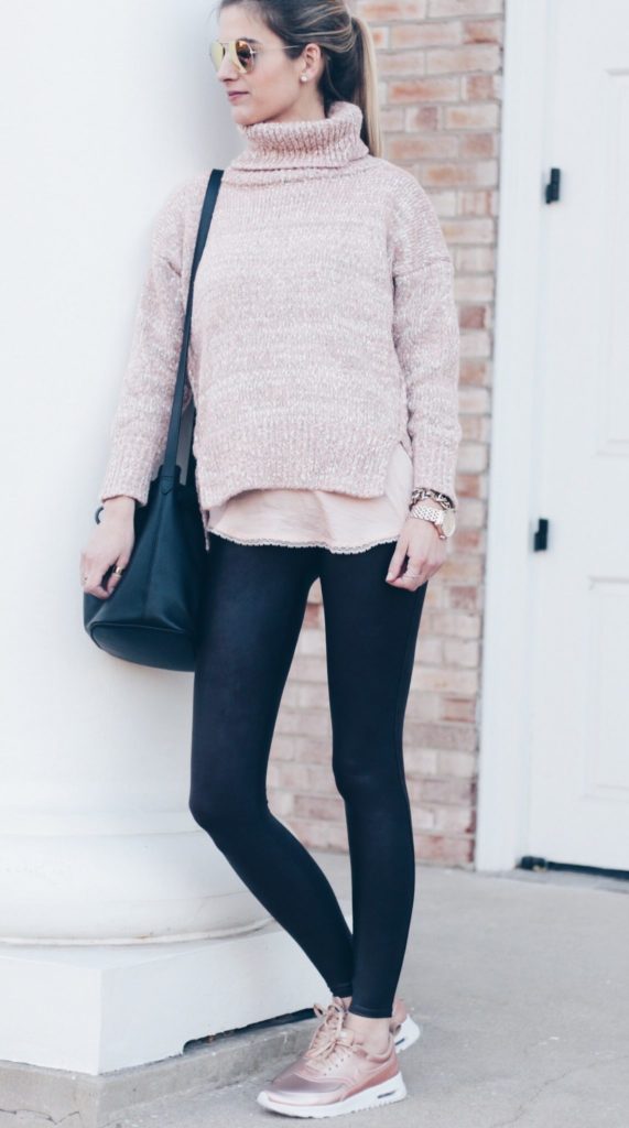 women's athleisure outfit: pink sweater with faux leather leggings and rose gold metallic sneakers