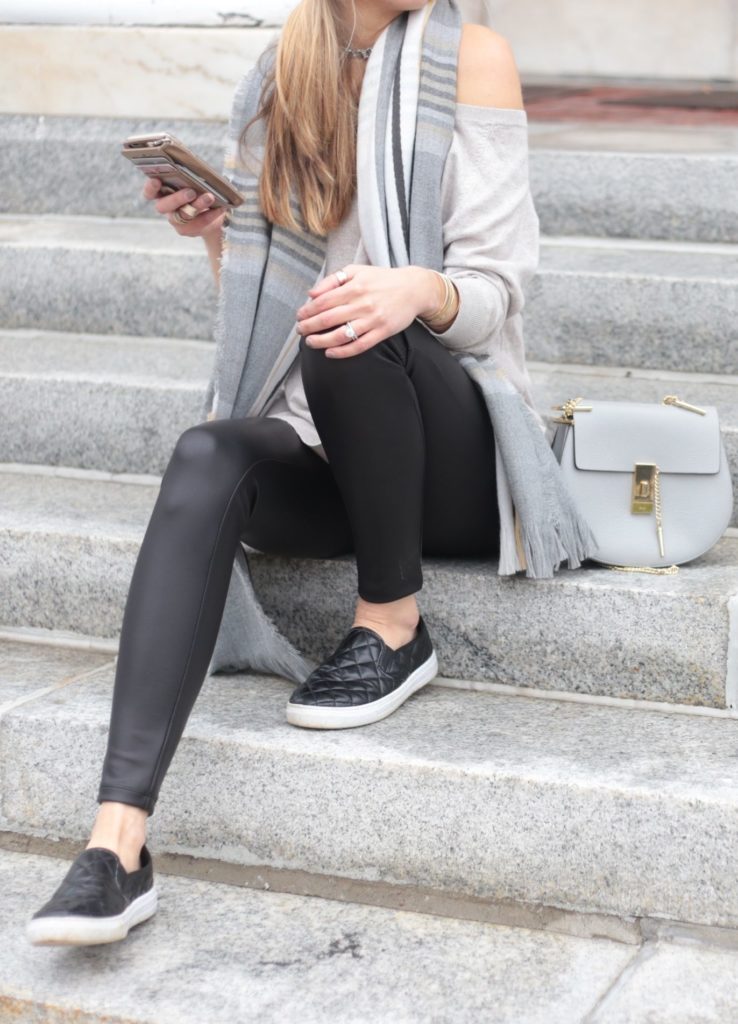 athleisure outfit with leather leggings, quilted sneakers, and slouchy sweater over lace bralette