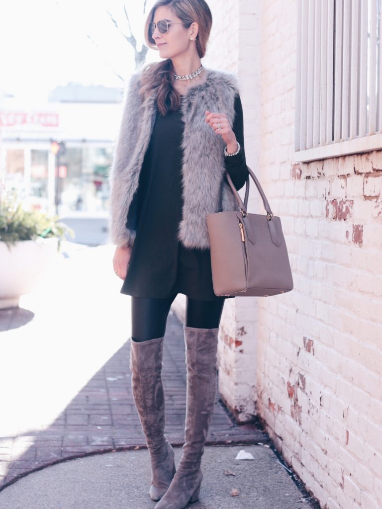 fur vest over green tunic dress and leggings with over the knee boots