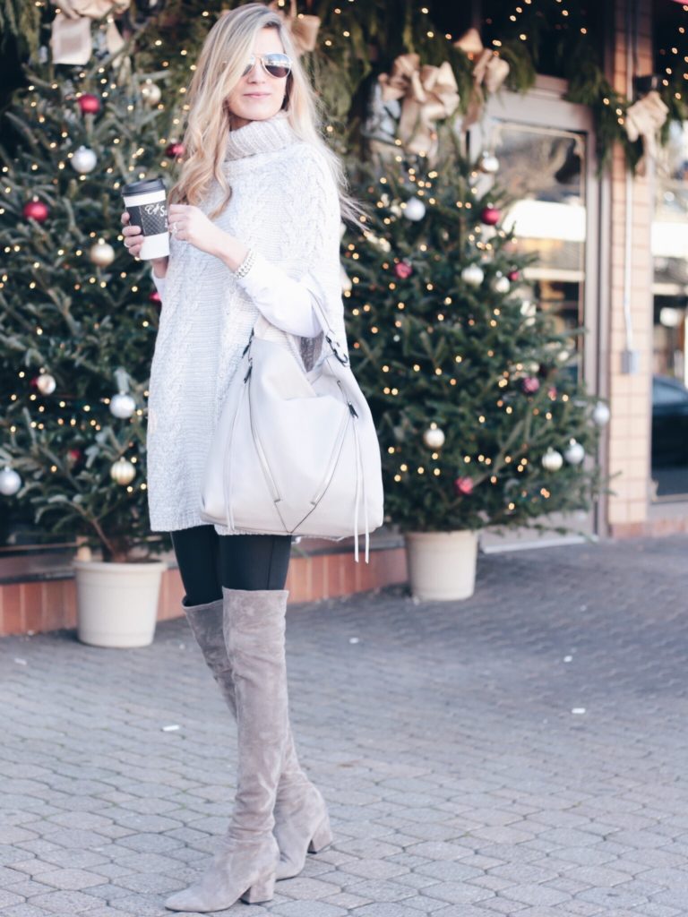 holiday outfit: leather leggings with over the knee boots and gray knit poncho