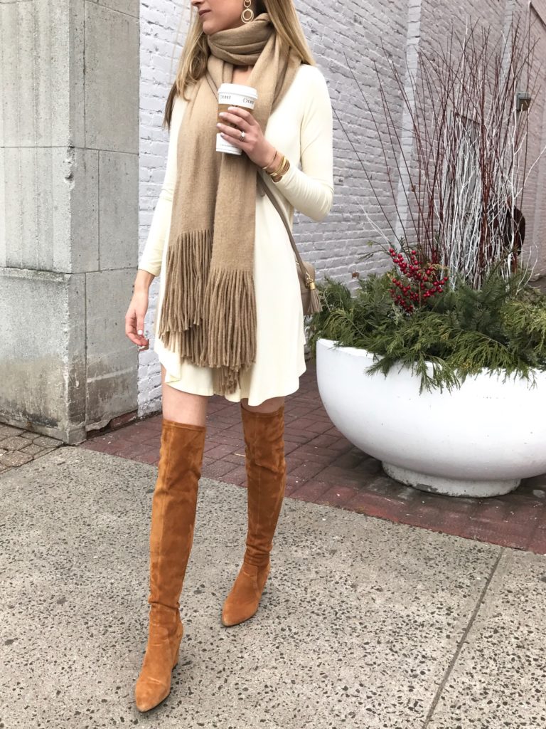 ivory swing dress with cognac over the knee boots and neutral fringe scarf