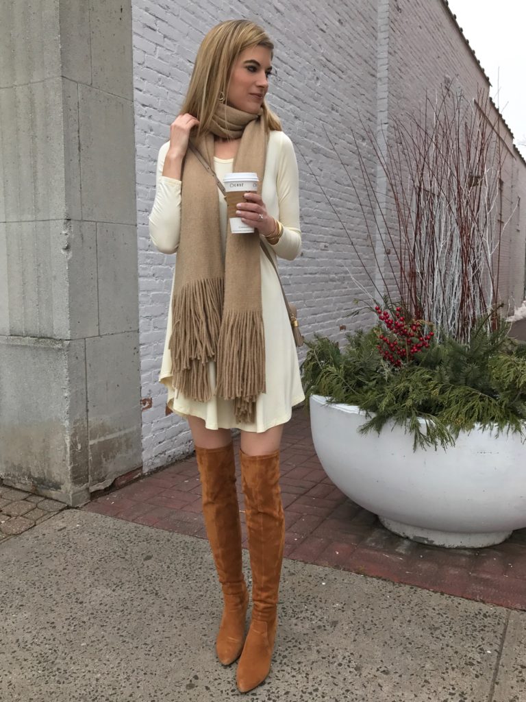ivory swing dress with cognac over the knee boots and tan fringe scarf