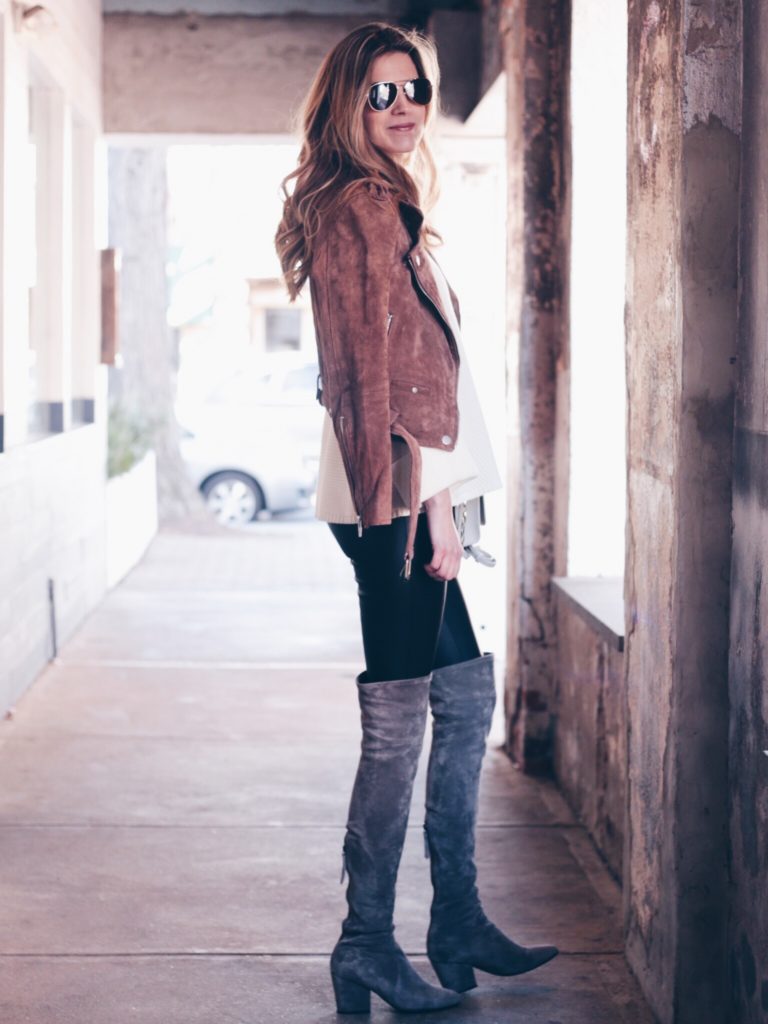 leather leggings outfit - taupe over the knee boots, white sweater, and brown suede moto jacket