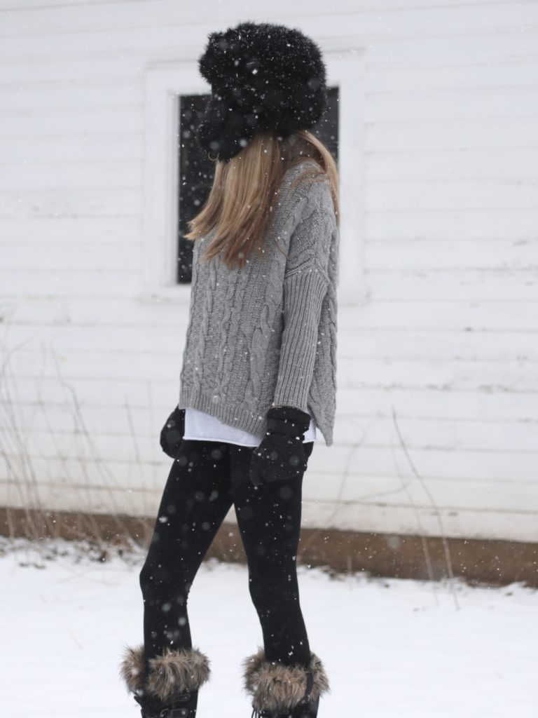 snow day outfit: cable knit gray sweater with fleece leggings and Sorel snow boots