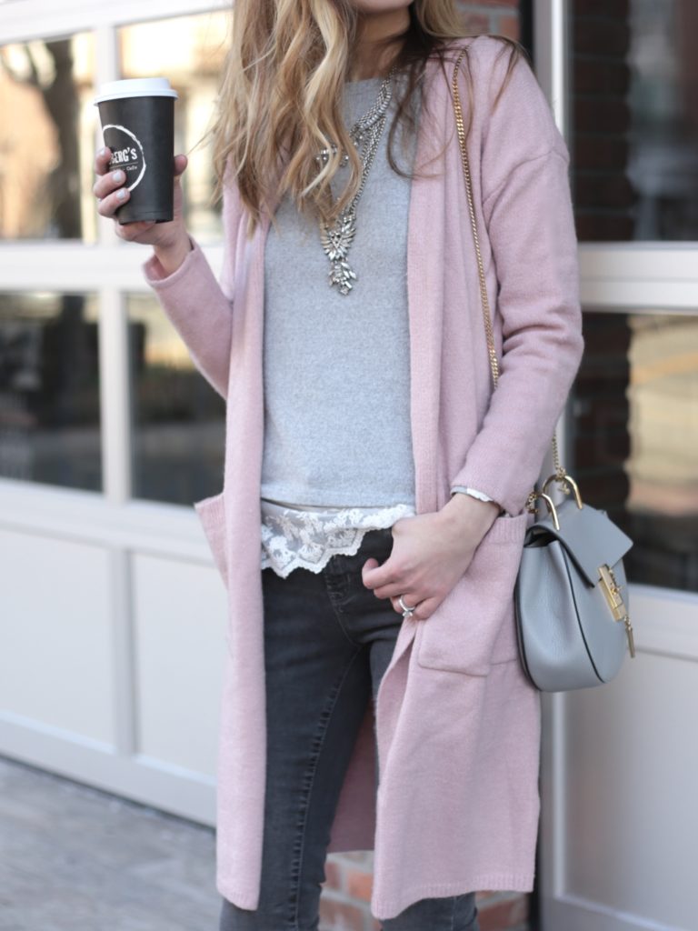 long pink sweater cardigan over gray lace knit top and gray skinny jeans