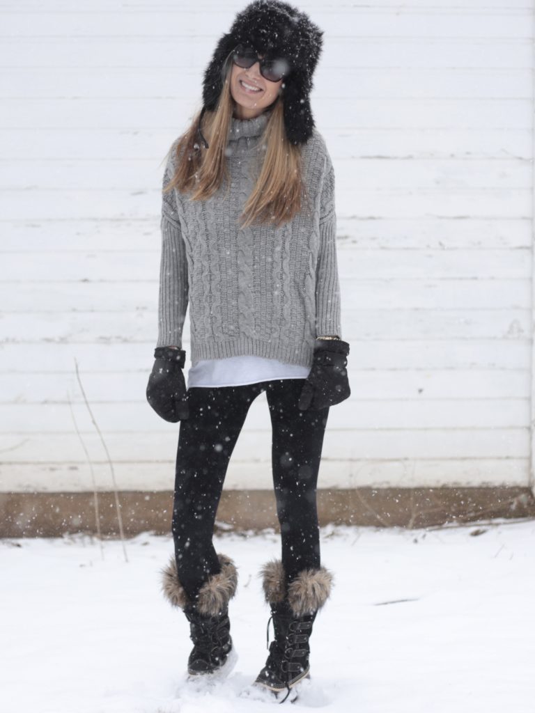 snow day outfit with gray cable knit sweater and Sorel snow boots