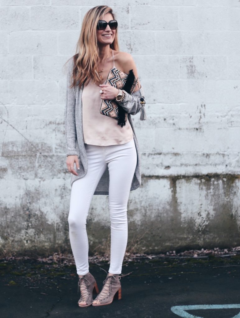 spring outfit: blush pink satin cami with gray long cardigan, white skinny jeans, and Jefferey Campbell lace up taupe booties