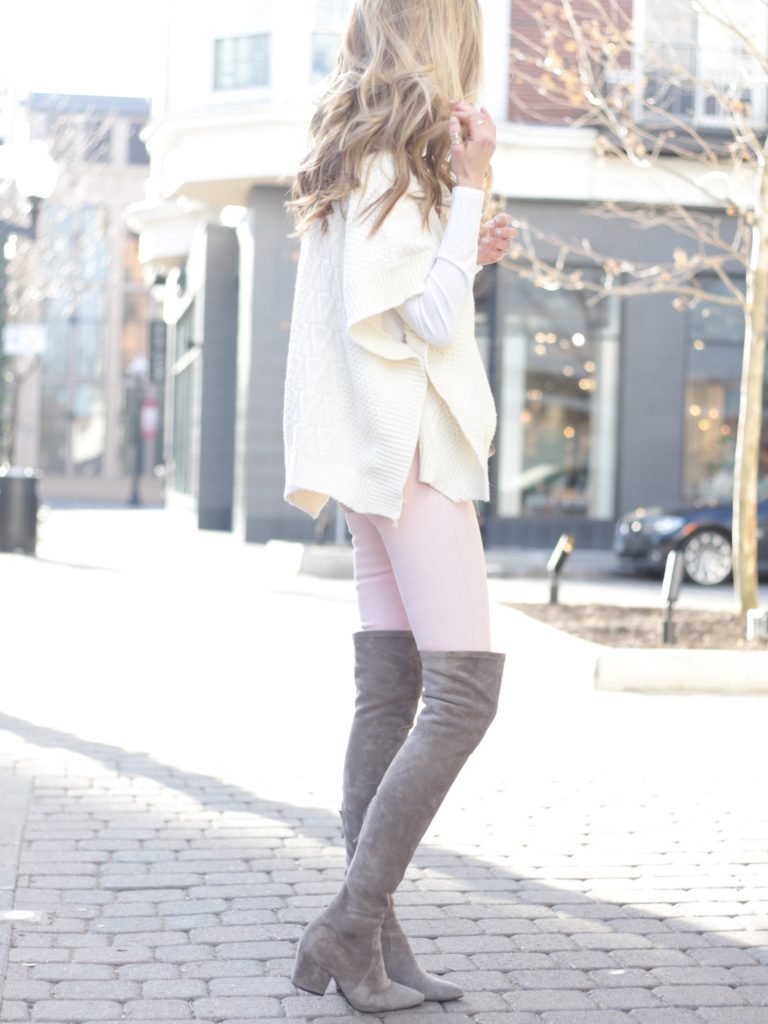 spring outfit: pink skinny jeans with white sweater poncho and over the knee boots