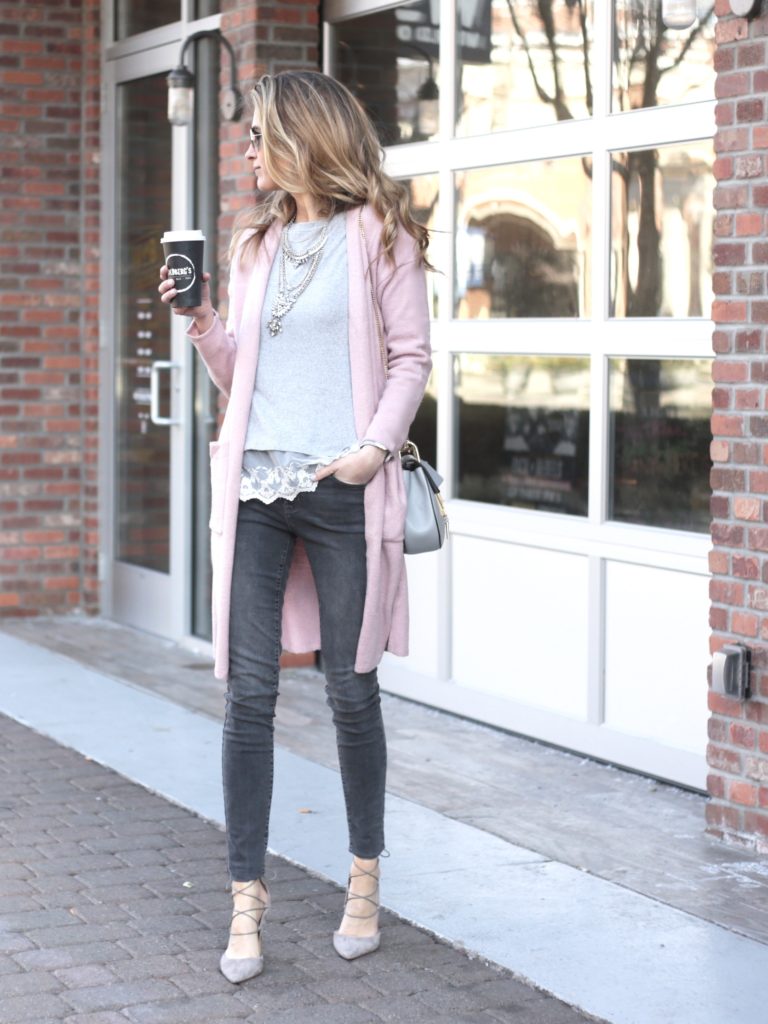 winter outfit: long pink sweater cardigan with gray skinny jeans and heels