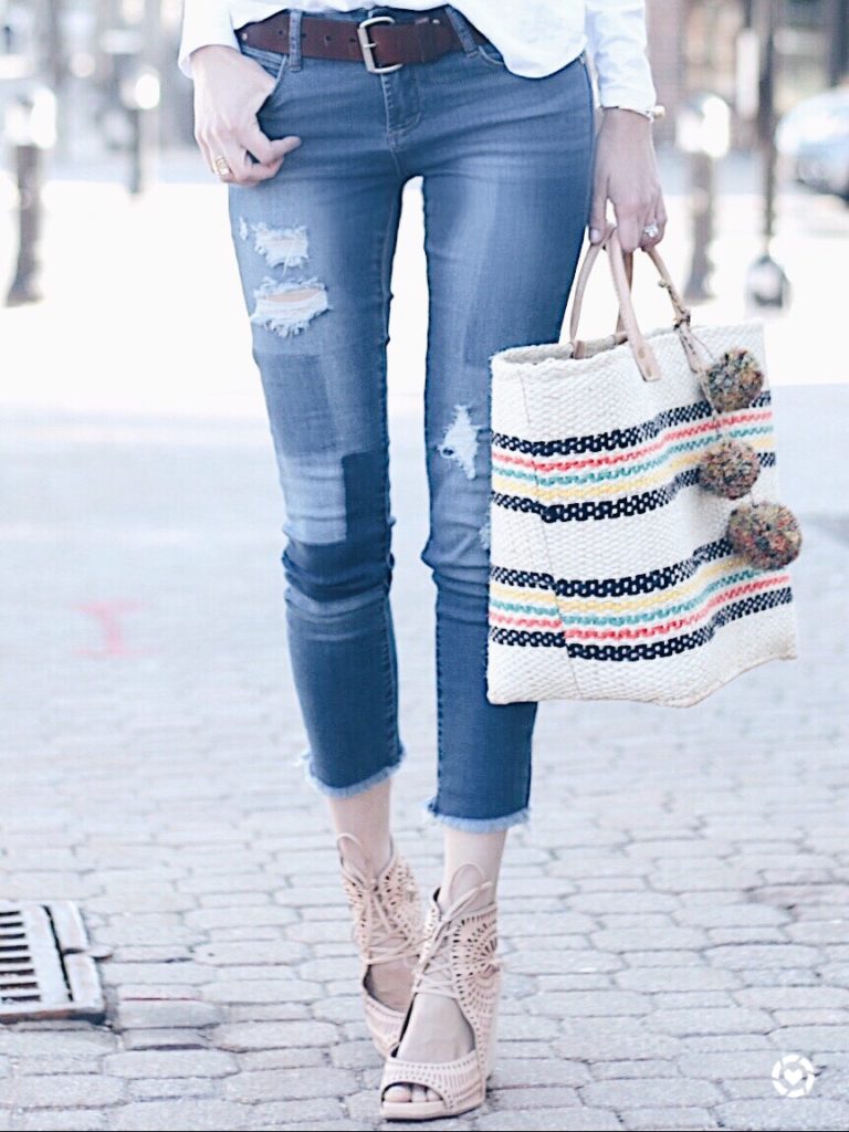 Connecticut life and style blogger, Pinteresting Plans shares a round-up of spring outfit ideas that she showcased on her Instagram. spring outfit idea: patchwork skinny jeans and straw beach tote with pom poms