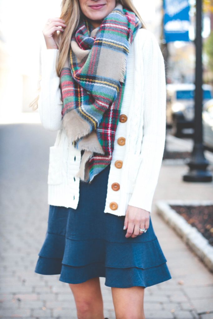 how to tie a blanket scarf for Fall over a blue ruffle hem FAll dress and ivory cable knit cardigan on pinterestingplans