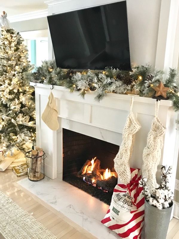 fireplace makeover before and after - the finished fireplace decorated for christmas