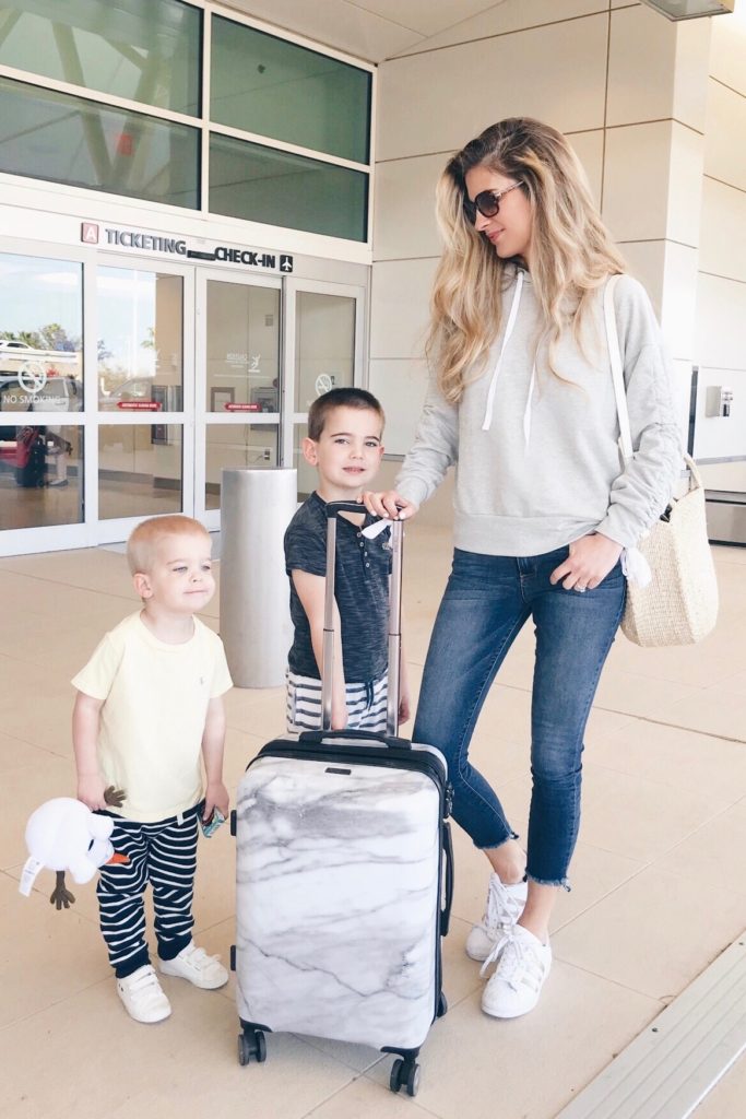 tips for packing light - lifestyle blogger pinteresting plans with kids at airport with marble suitcase