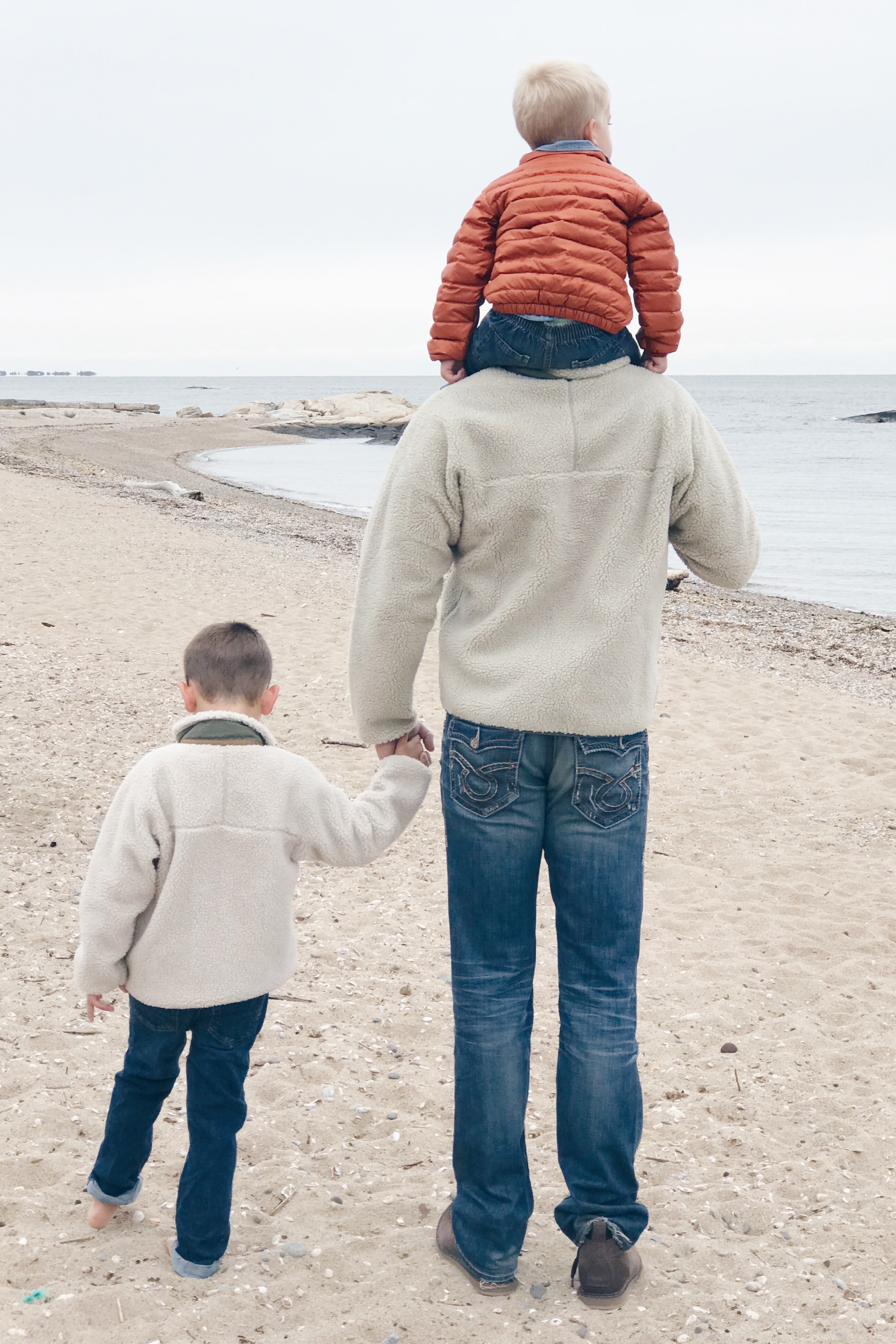 Fall Bucket list for families - family at the beach in Patagnia jackets