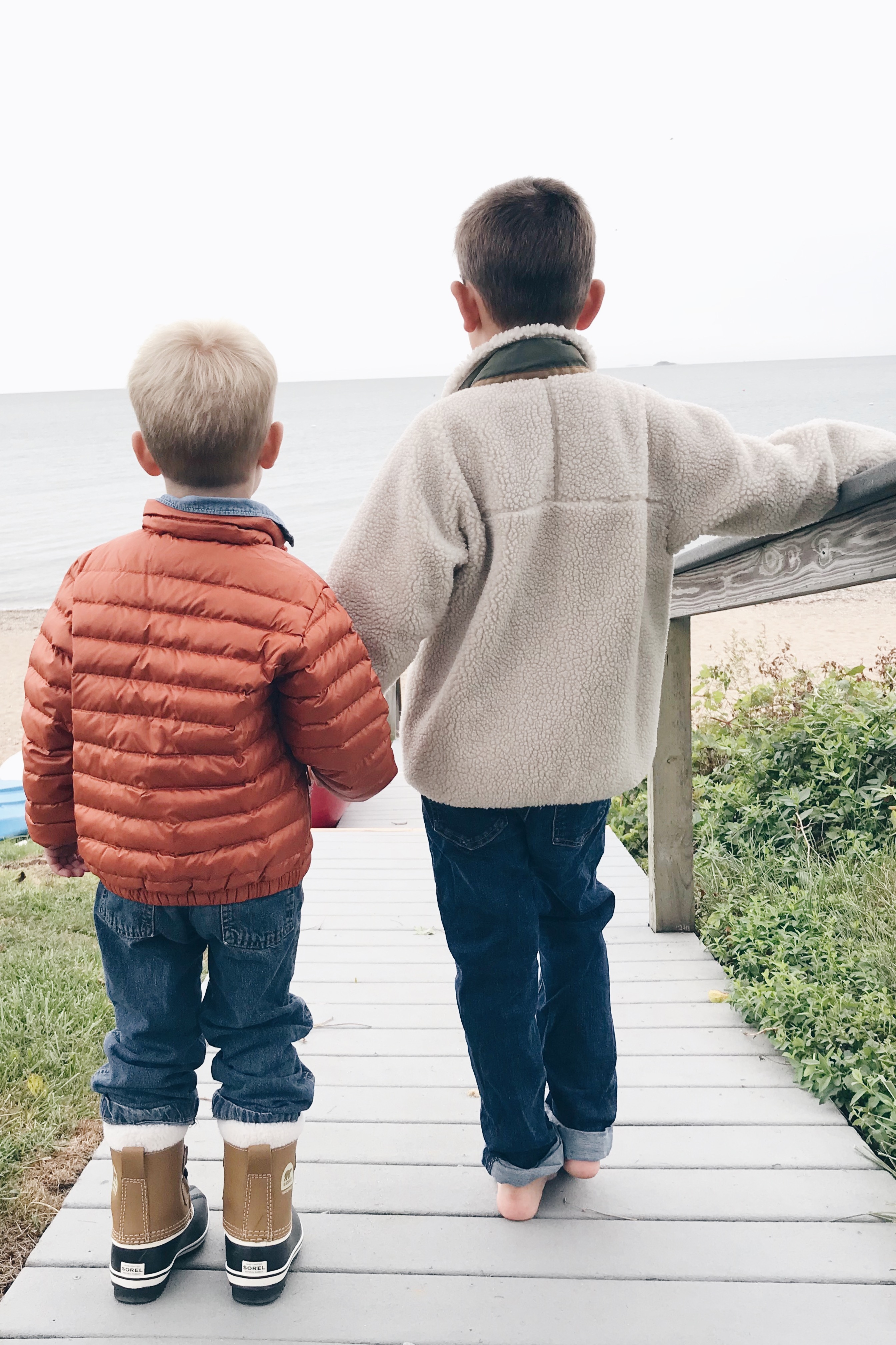 Fall bucket list for families - little boys in Patagonia jackets at the beach