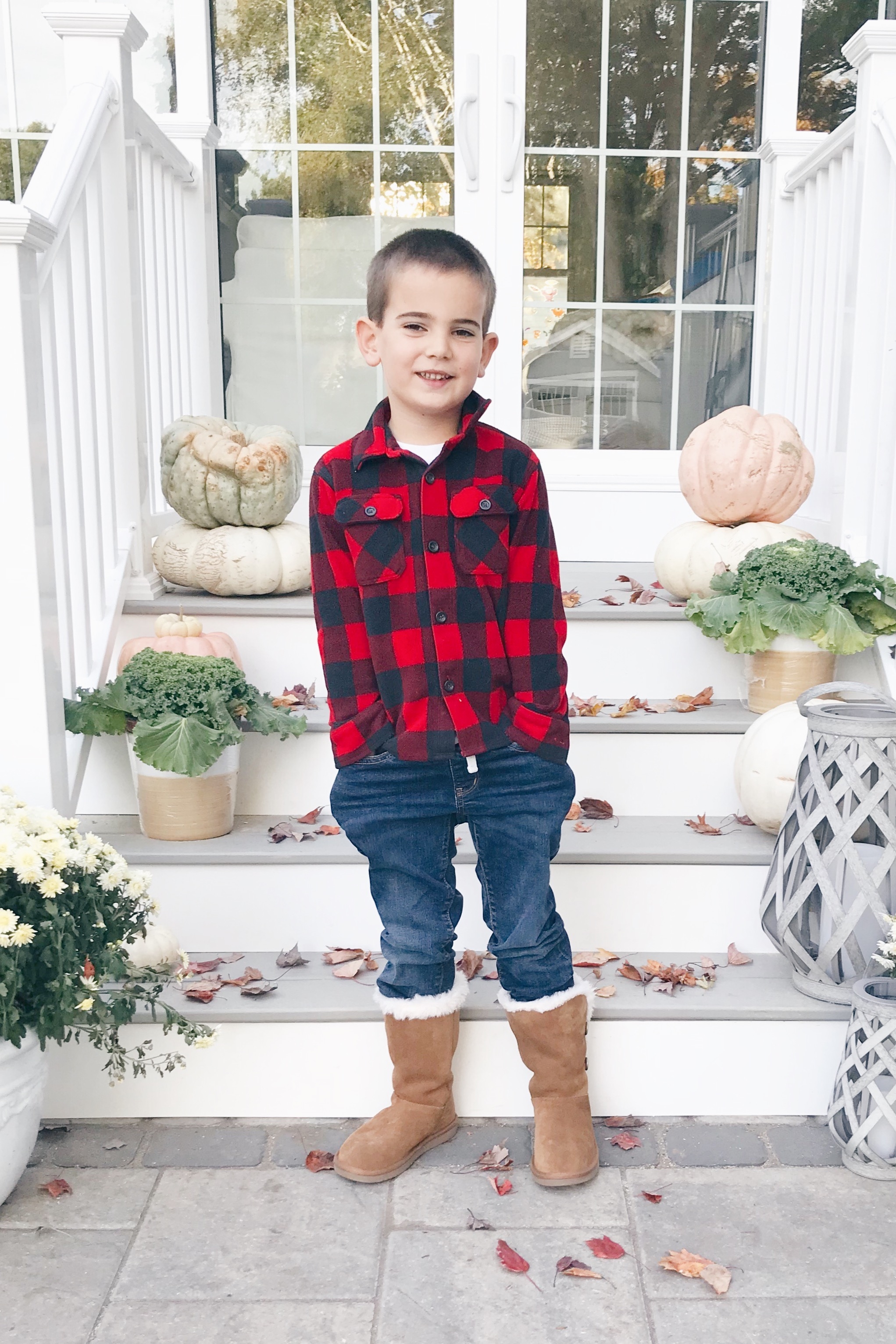  little boy wearing fall outfit with koolaburra boots