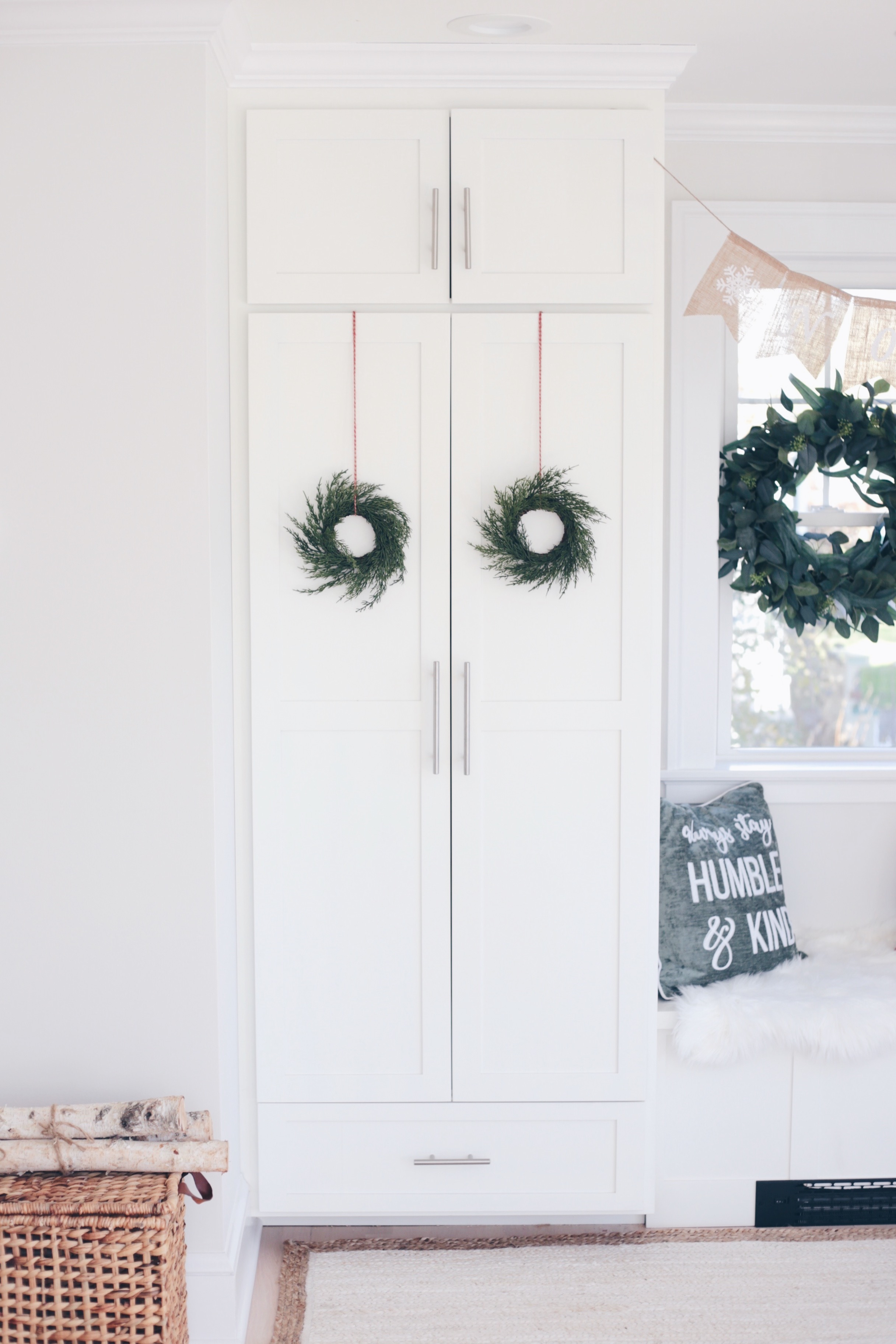  simple holiday mudroom decor - wreaths on white shaker doors on pinteresting plans blog