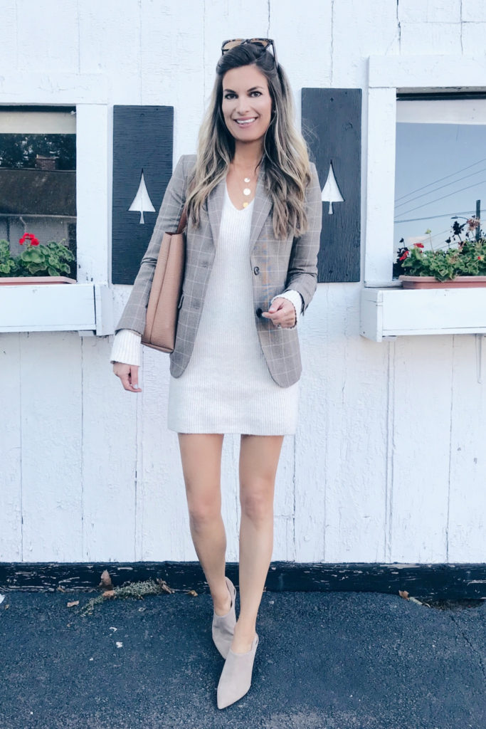 fashion blogger styling something navy sweater dress with booties for work