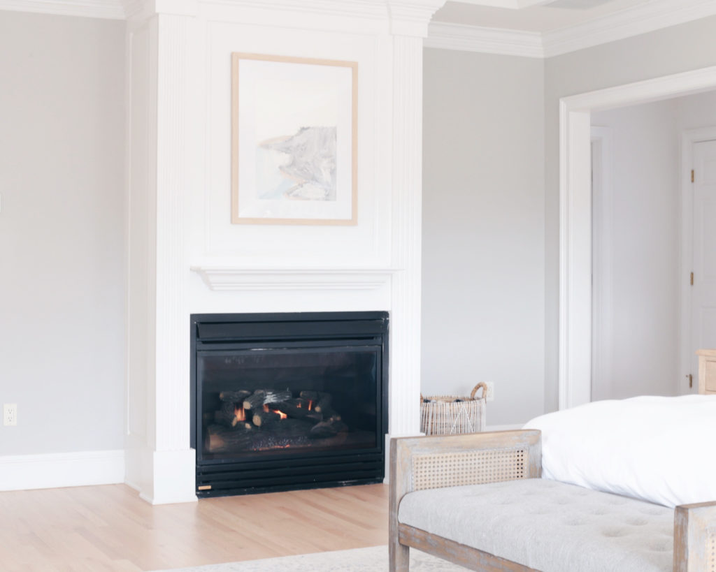 modern master bedroom with framed art  above fireplace - pinteresting plans blog