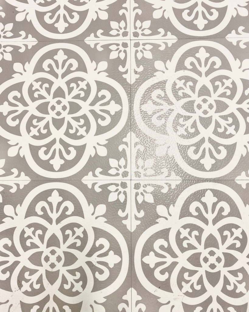 peel and stick tile review - gray stenciled tile in laundry room - pinteresting plans blog