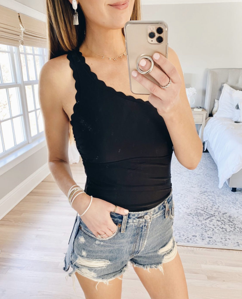 black one shoulder one piece swimsuit with distressed denim shorts