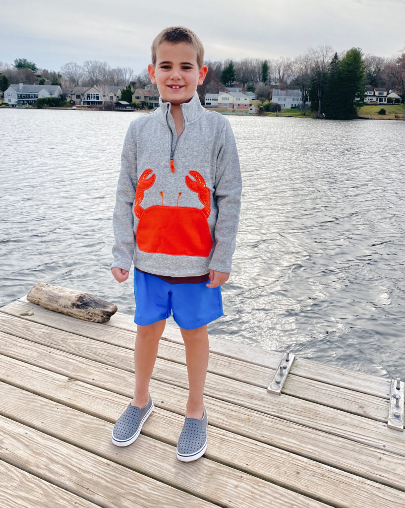 kids outfit beach essentials - water shoes, striped swim trunks and crab applique sweatshirt