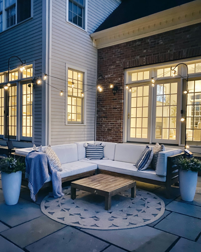 how to hang outdoor string light over your patio furniture