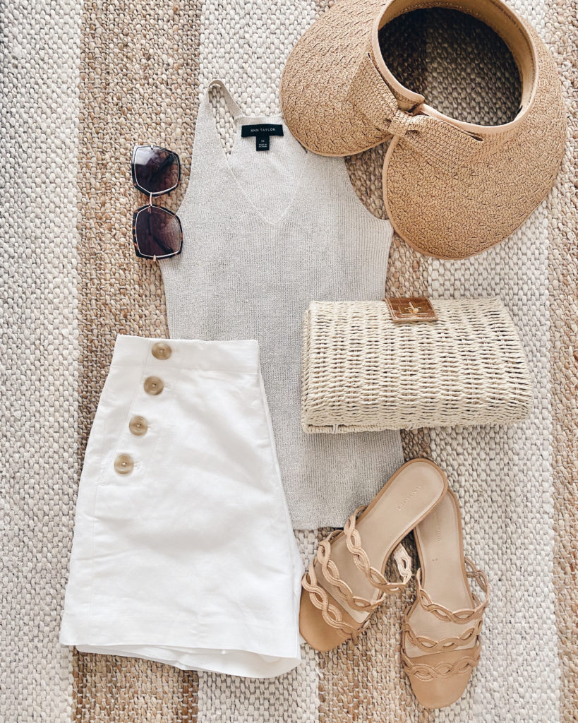 neutral summer outfit - beige sweater tank with white sailor shorts and woven clutch and visor