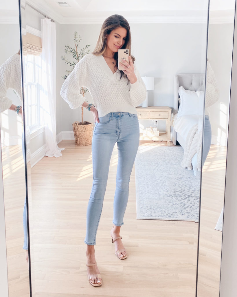 spring outfit 2021 - white vneck sweater with light wash jeans and heels