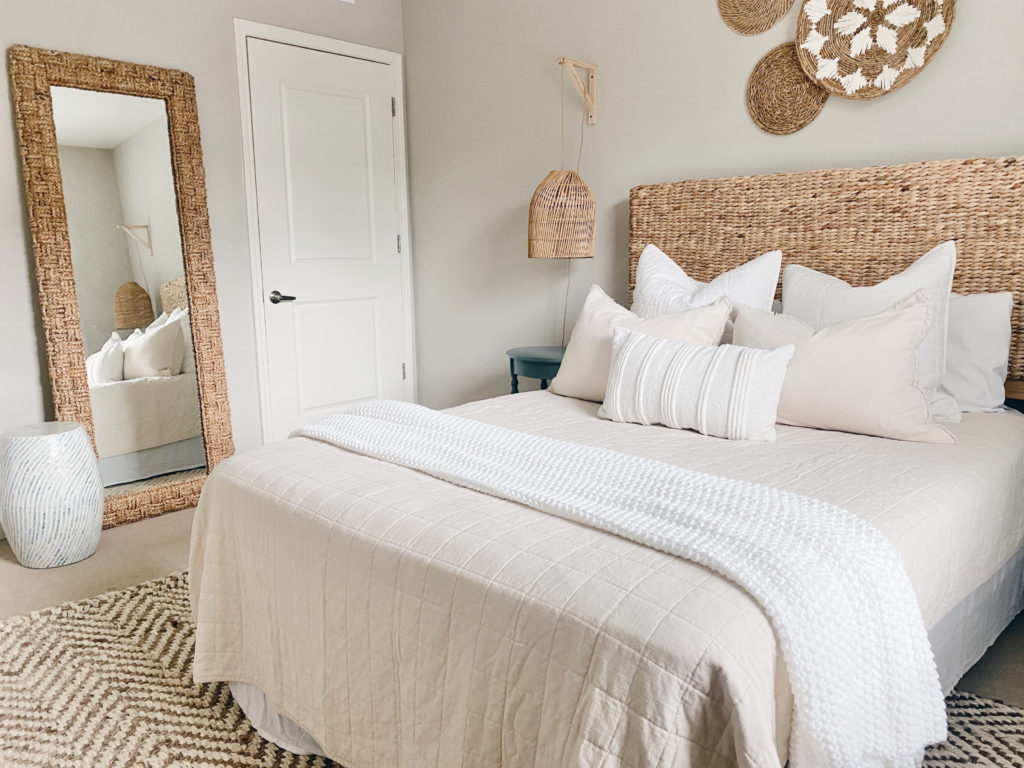 layered neutral bedding in a modern coastal beach bedroom