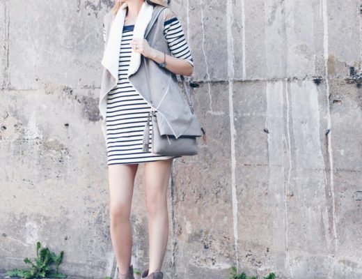 fall outfit: shearling vest over striped dress with tan booties