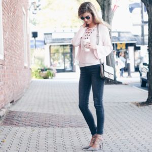 pink lace up sweater outfit with gray skinny jeans