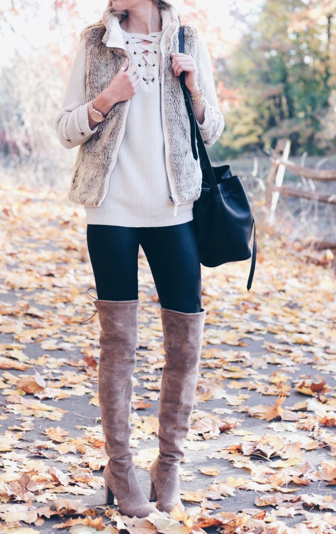 brown over the knee suede boots with leather leggings, lace up sweater and fur vest