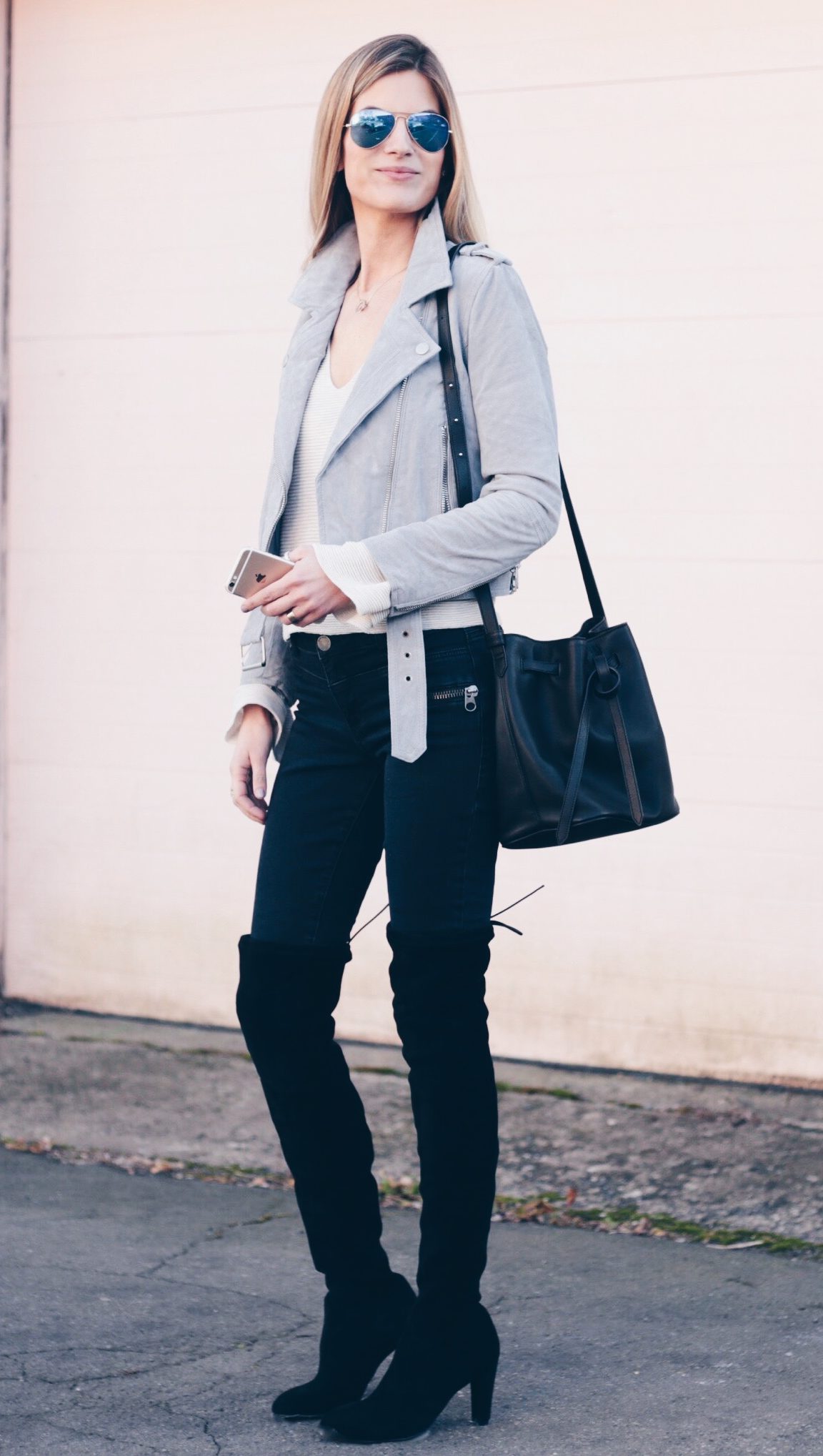 gray suede moto jacket over free people bell sleeve sweater with black over the knee boots