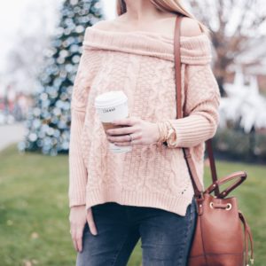 pink cable knit sweater and cognac bucket bag