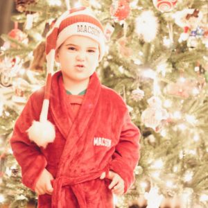 child in robe and christmas night cap