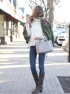 embroidered jacket over white turtleneck sweater and jeggings