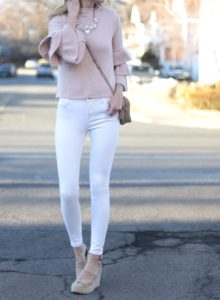 spring outfit: pink ruffled bell sleeve sweater with white skinny jeans