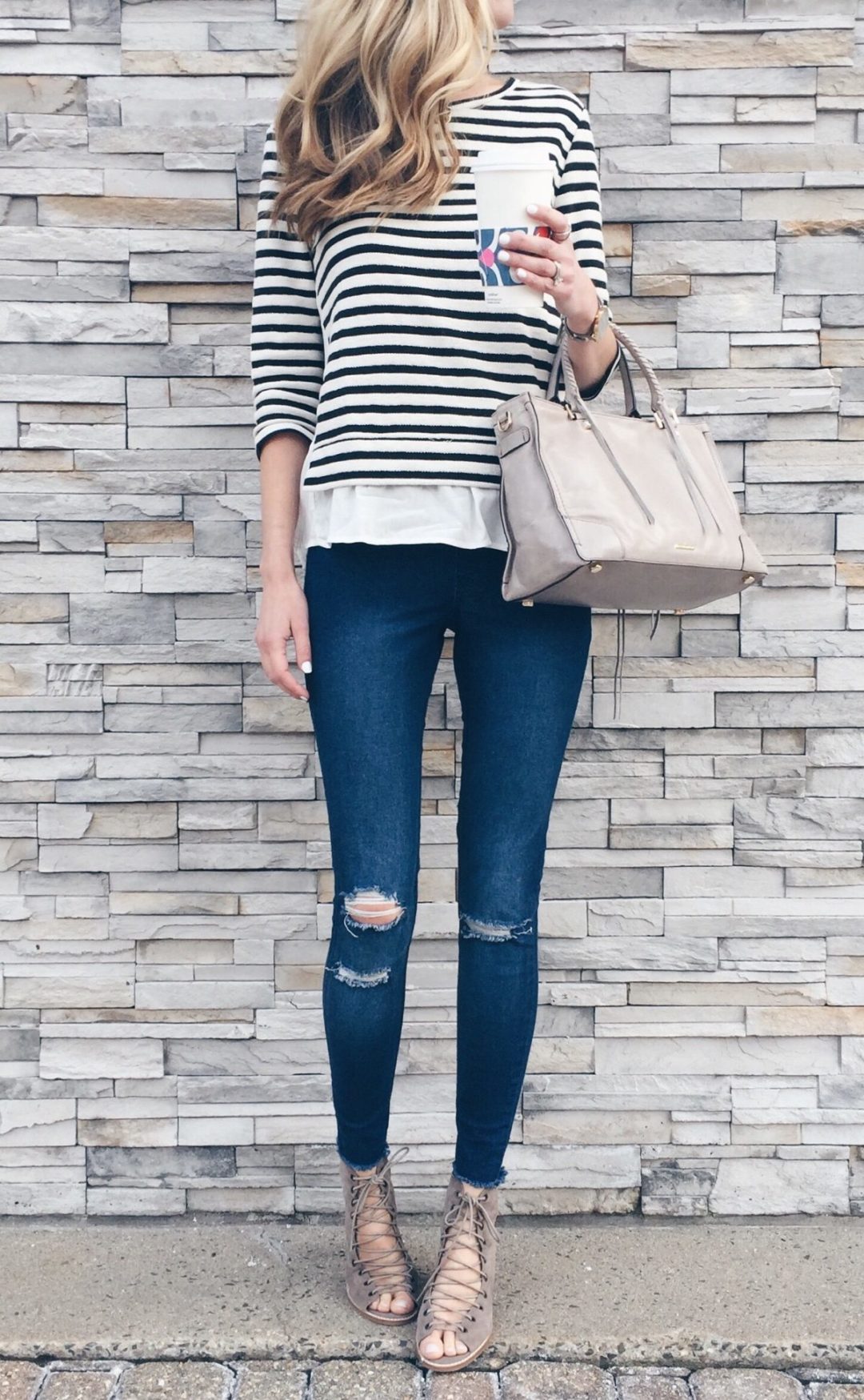spring outfit idea: striped ruffle hem top with skinny jeans and lace up booties
