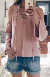 spring outfit ideas - lace up sweatshirt over lace bralette