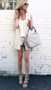 summer outfit ideas - neutral vest over white shorts and cami