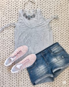 summer outfit ideas - tie sleeve tee with cut offs and pink adidas gazelle sneakers