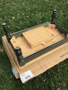 farmhouse coffee table makeover - spray painting the legs